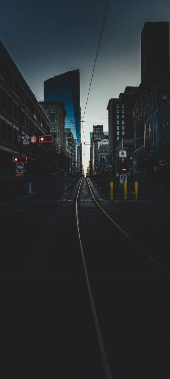 Обои городской район, здание, небоскреб, автомобильное освещение, башня в разрешении 1080x2400